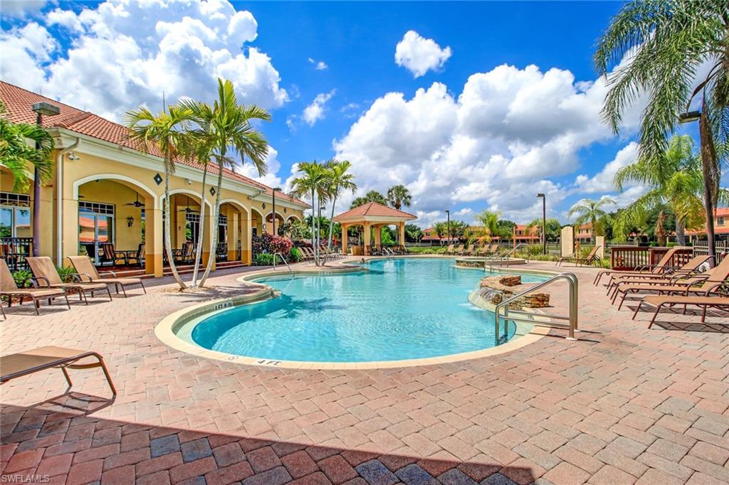 15243 Summit Pl Circle, Unit 247 Naples, FL 34119 - Photo 16 of 18 a swimming pool with outdoor seating and yard