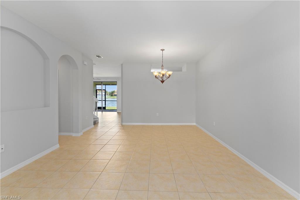 15243 Summit Pl Circle, Unit 247 Naples, FL 34119 - Photo 2 of 18 an empty room with cabinet and windows