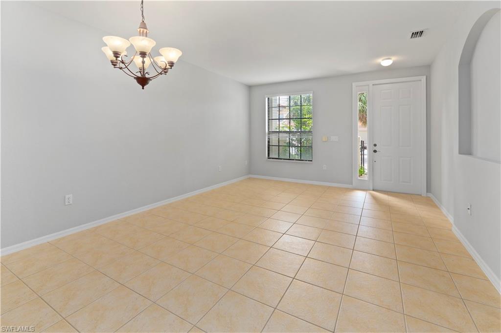 15243 Summit Pl Circle, Unit 247 Naples, FL 34119 - Photo 3 of 18 a view of an empty room with a window