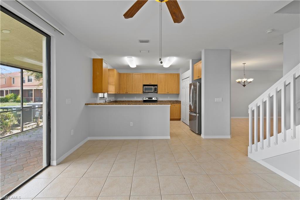 15243 Summit Pl Circle, Unit 247 Naples, FL 34119 - Photo 4 of 18 a kitchen with granite countertop a refrigerator and a sink