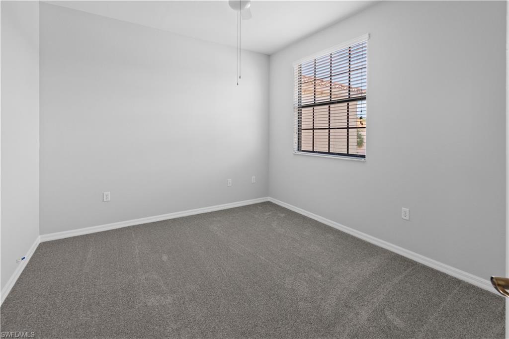 15243 Summit Pl Circle, Unit 247 Naples, FL 34119 - Photo 9 of 18 an empty room with a window