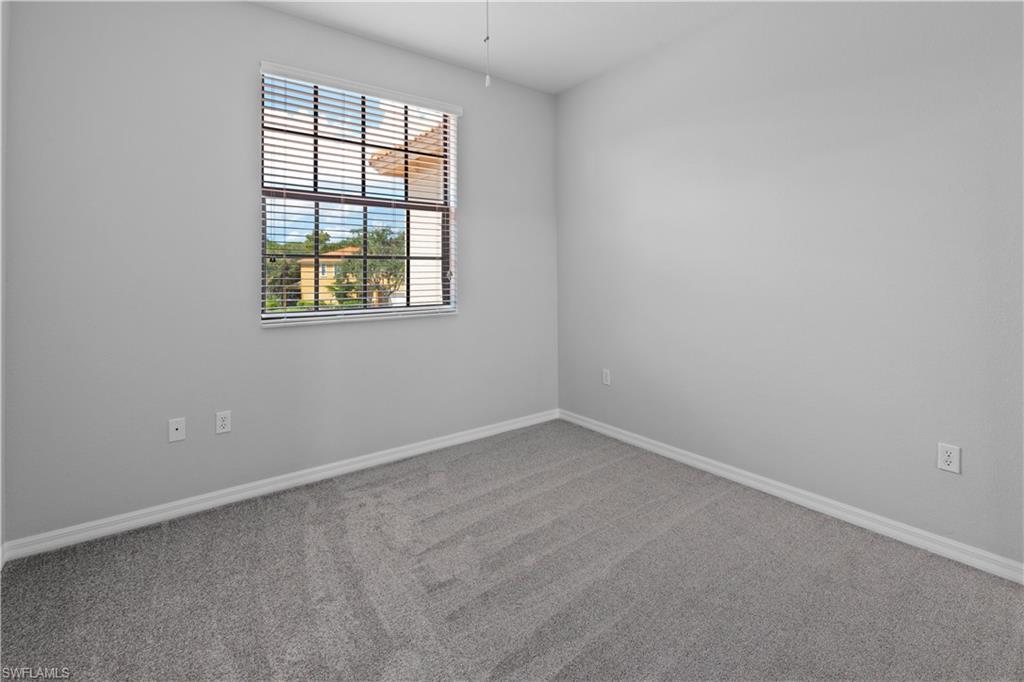 15243 Summit Pl Circle, Unit 247 Naples, FL 34119 - Photo 10 of 18 an empty room with a window