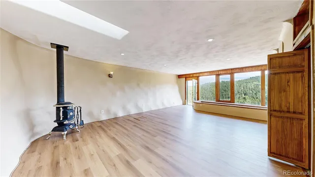 a view of a bedroom with a bed and wooden floor