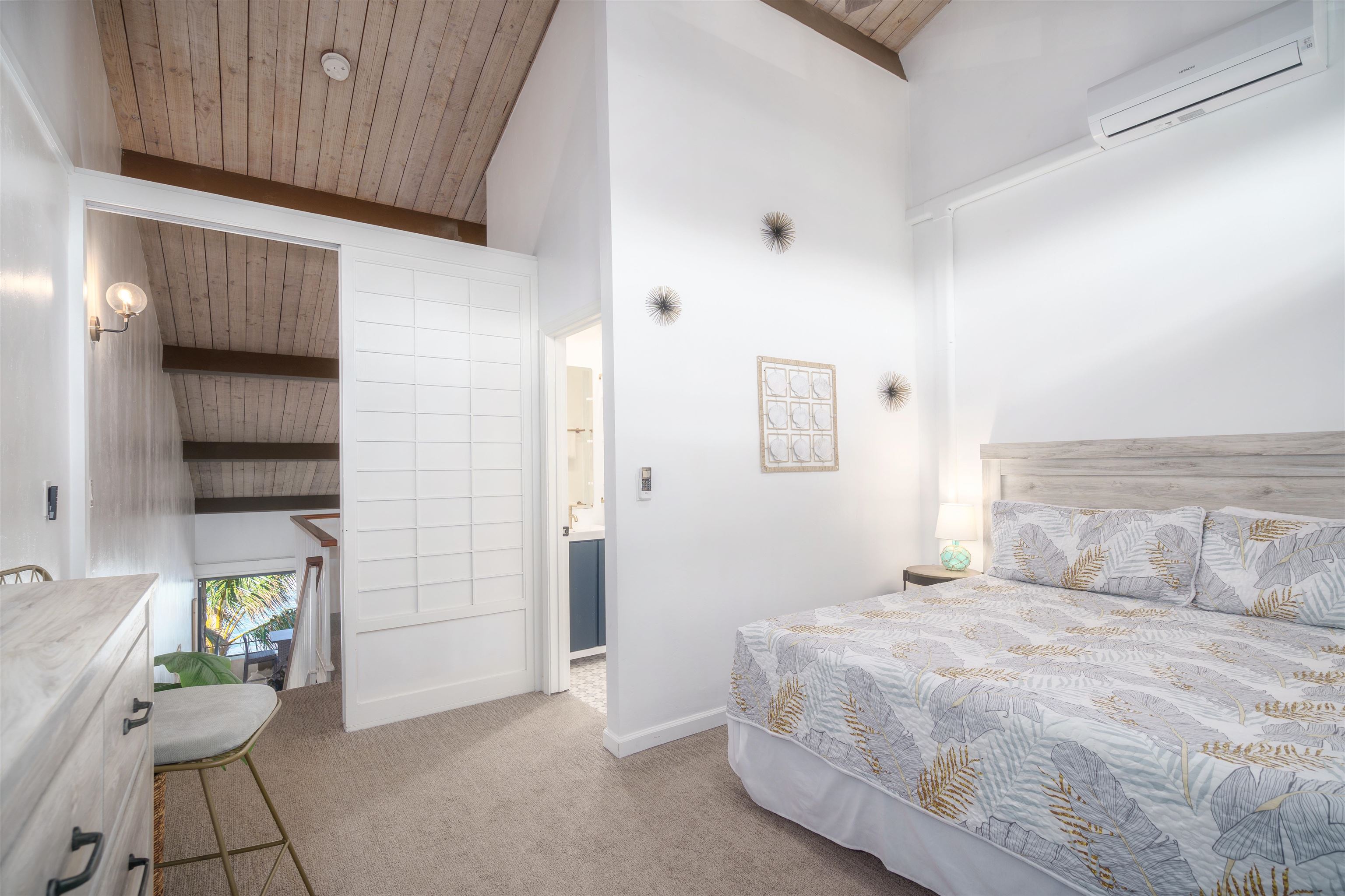 3741 Lower Honoapiilani Road, Unit 303 Lahaina, HI 96761 - Photo 15 of 30 a bedroom with a bed and a potted plant