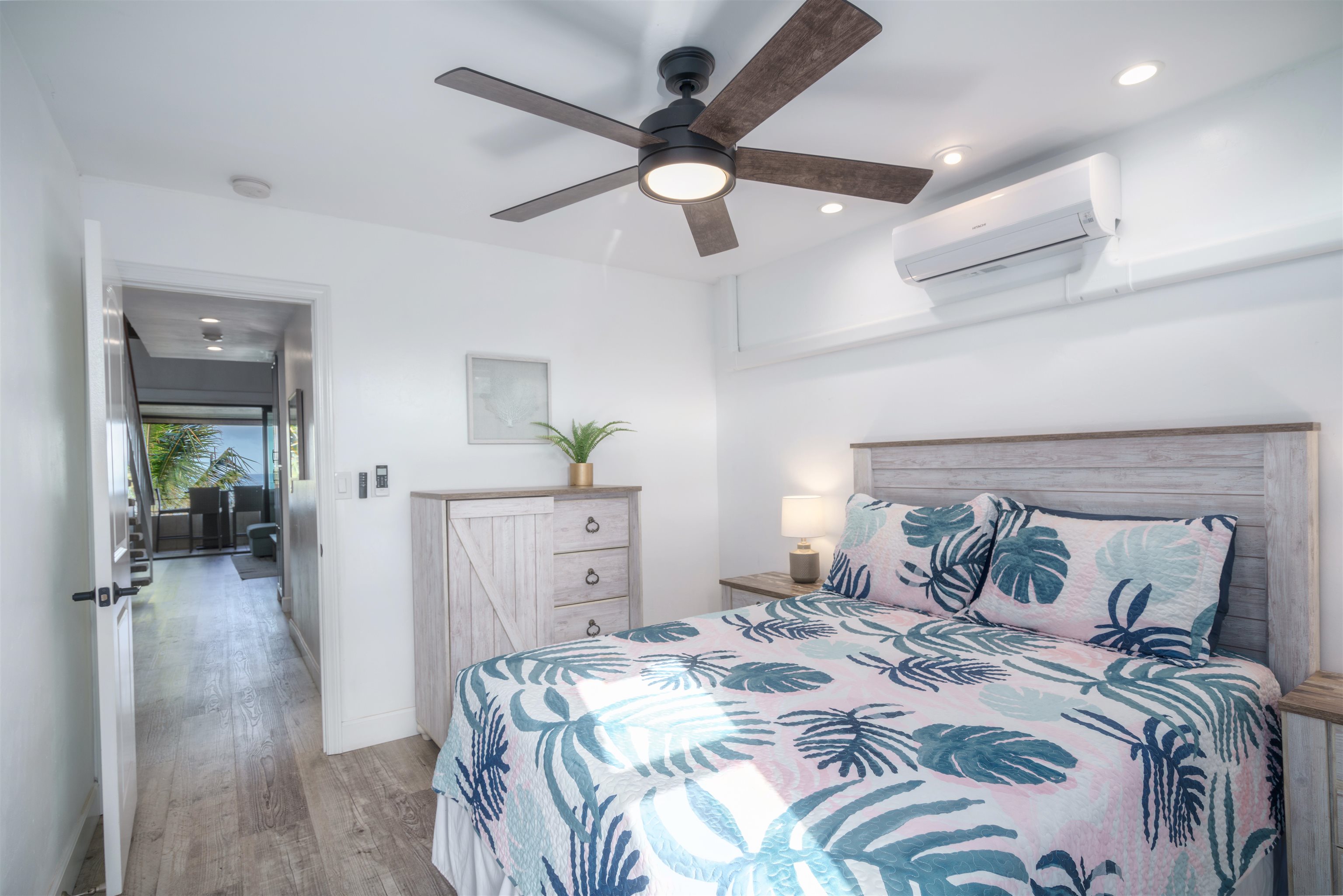 3741 Lower Honoapiilani Road, Unit 303 Lahaina, HI 96761 - Photo 20 of 30 a bedroom with a bed and a chandelier