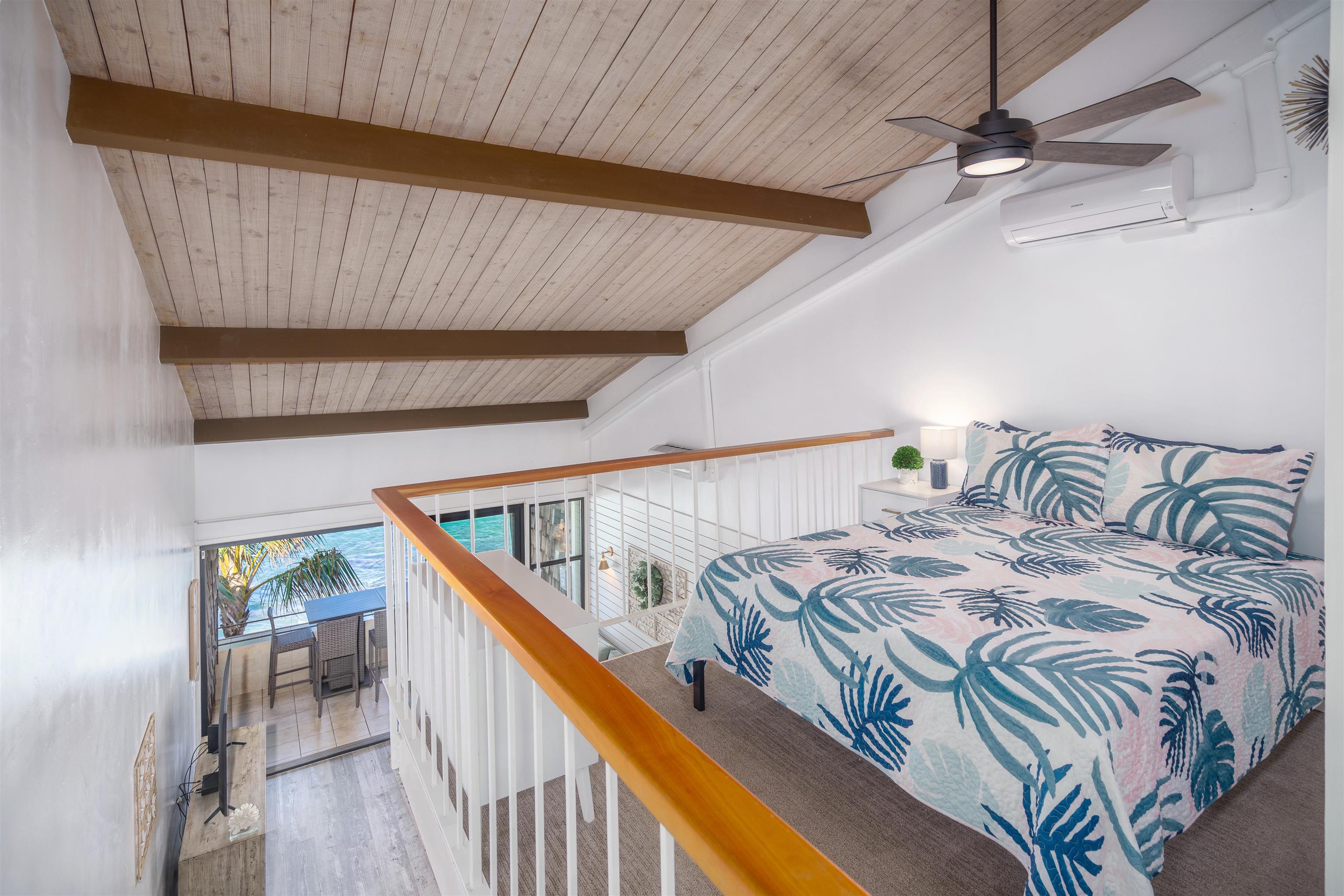 3741 Lower Honoapiilani Road, Unit 303 Lahaina, HI 96761 - Photo 23 of 30 a bed sitting in a bedroom next to a window