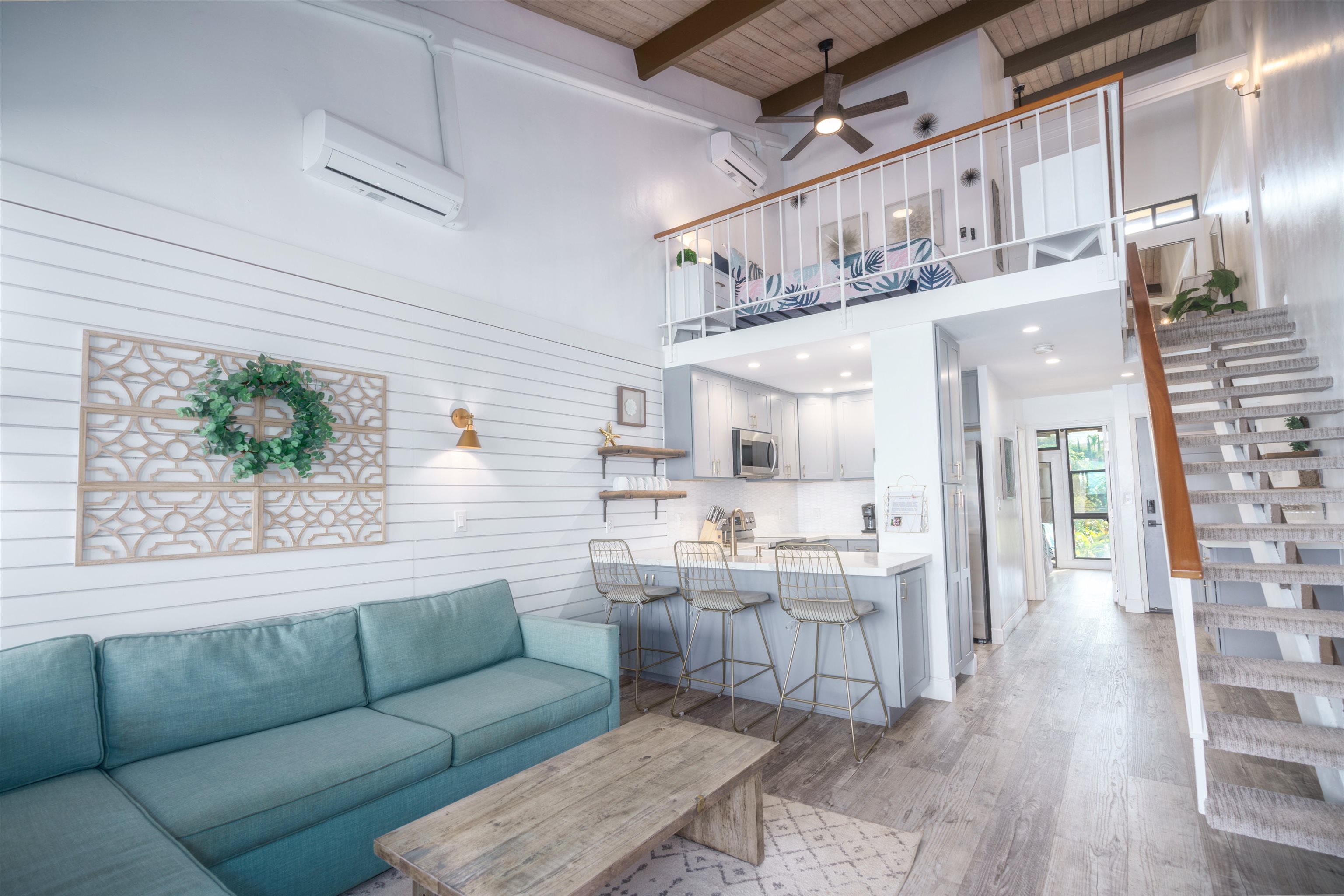 3741 Lower Honoapiilani Road, Unit 303 Lahaina, HI 96761 - Photo 4 of 30 a living room with stainless steel appliances kitchen island granite countertop furniture and a wooden floor