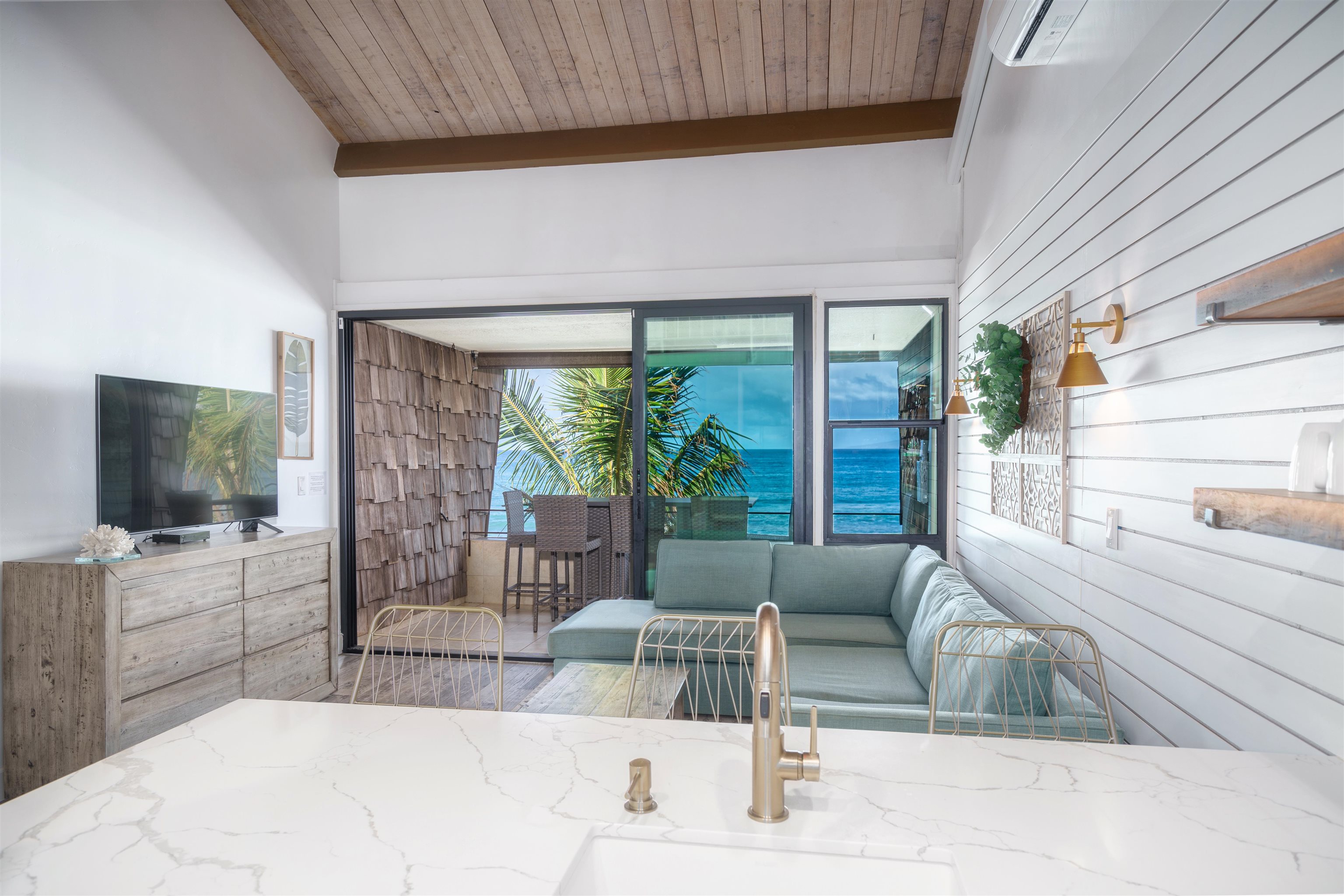 3741 Lower Honoapiilani Road, Unit 303 Lahaina, HI 96761 - Photo 6 of 30 a living room with furniture and a flat screen tv