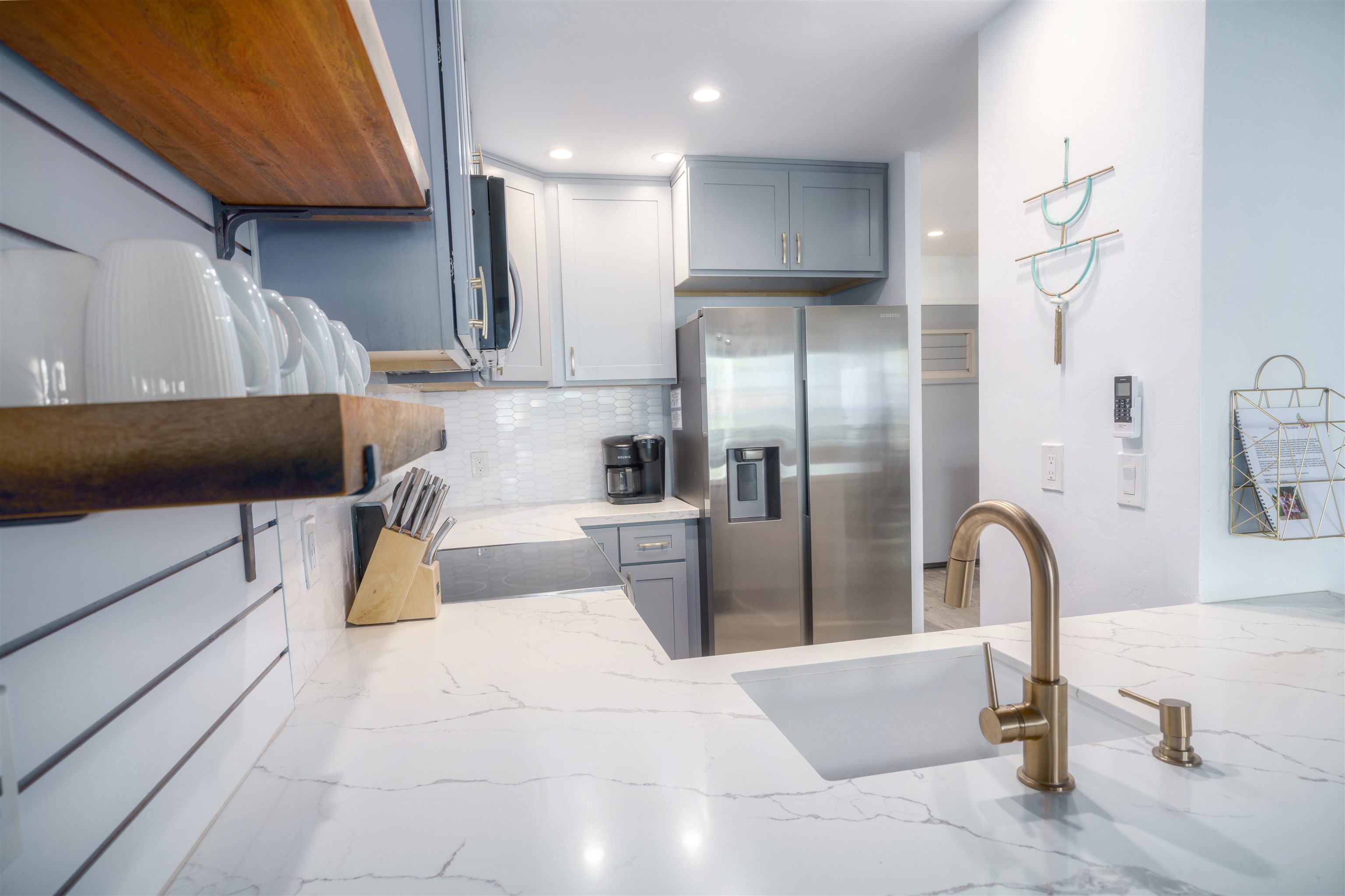 3741 Lower Honoapiilani Road, Unit 303 Lahaina, HI 96761 - Photo 10 of 30 a kitchen with a refrigerator and a sink