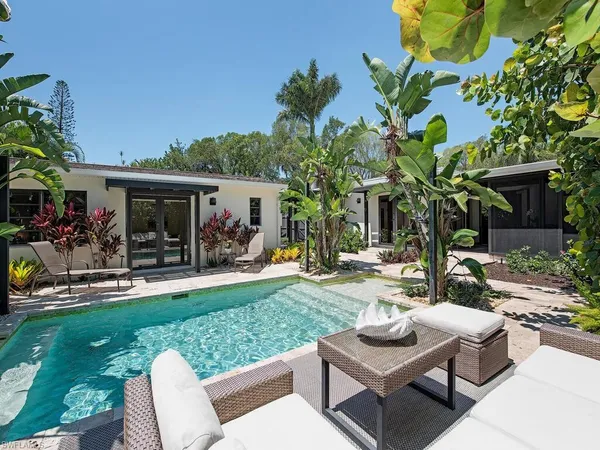 a view of a house and a back yard with a patio