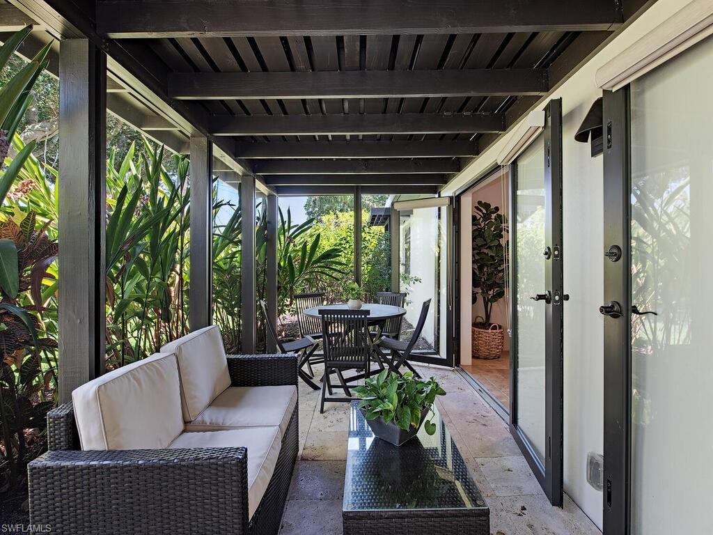 1200 9th Avenue North Naples, FL 34102 - Photo 20 of 22 a outdoor living space with furniture and garden view