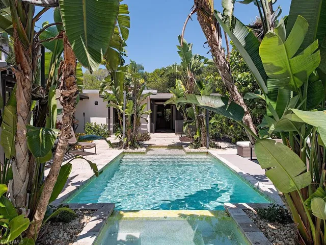 a view of a house with fountain and porch