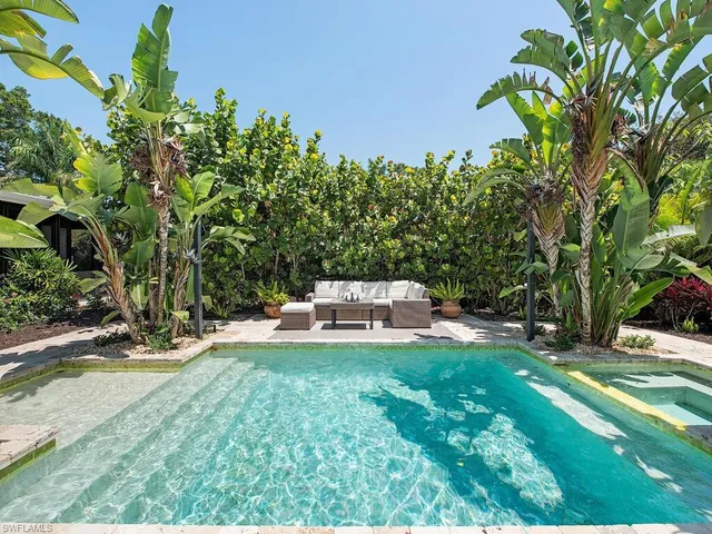 a white house with a yard and sitting area