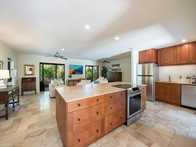 a kitchen with stainless steel appliances granite countertop a stove oven and a refrigerator