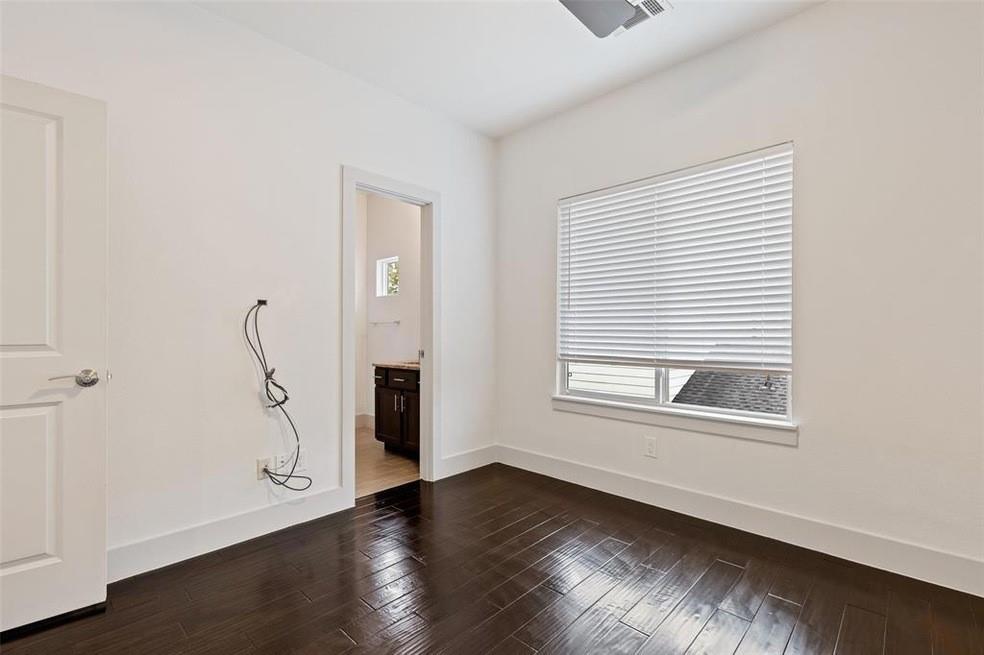 5924 Hudson Street, Unit F Dallas, TX 75206 - Photo 12 of 25 an empty room with wooden floor and windows