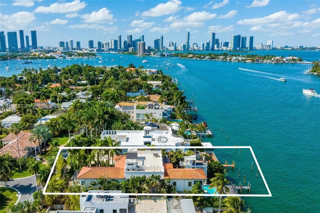 a view of a house with swimming pool and sitting area