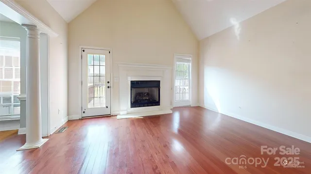 a living room with furniture and kitchen view