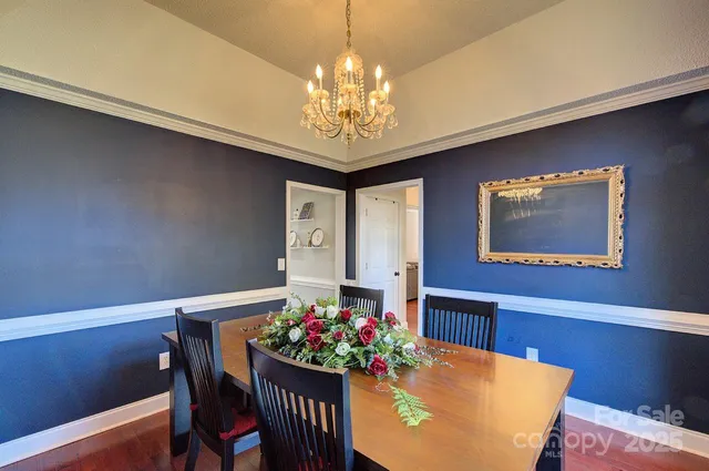 a dining room with furniture a rug and a chandelier