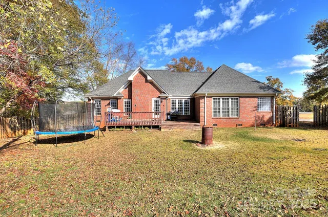 a view of a yard with wooden fence
