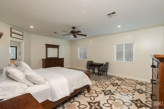 a bedroom with a bed a window and a chandelier