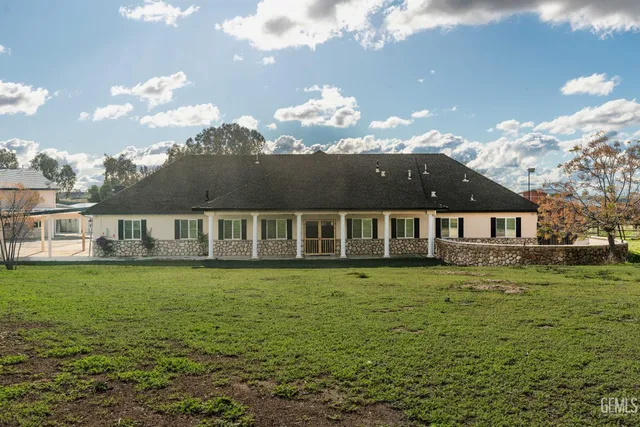 a view of a swimming pool with an outdoor seating and a shower