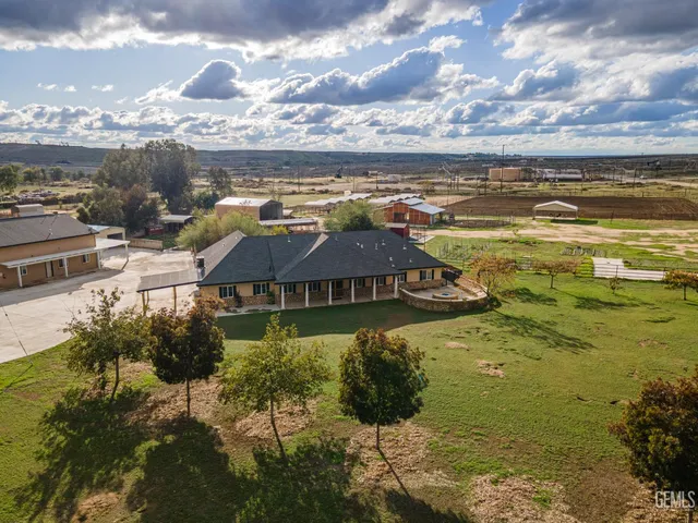 a view of swimming pool in front of residential houses with city view