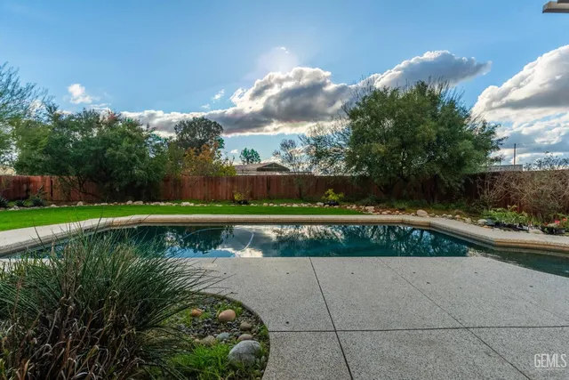 a view of an empty room with wooden floor and closet