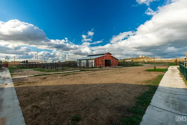 a view of a city with lawn chairs and large trees