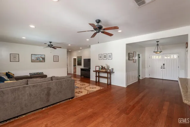 a kitchen with stainless steel appliances kitchen island granite countertop a table and chairs in it