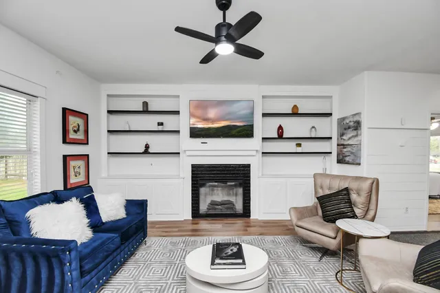 a living room with furniture and a fireplace