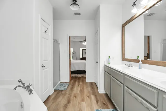 a spacious bathroom with a sink and a mirror