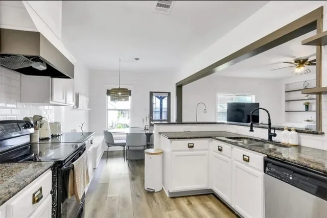 a kitchen with a sink stove and cabinets