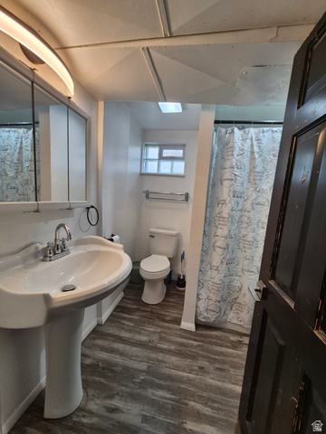 327 North 300 West Logan, UT 84321 - Photo 10 of 12 Full bathroom with a shower with curtain and dark wood-style flooring