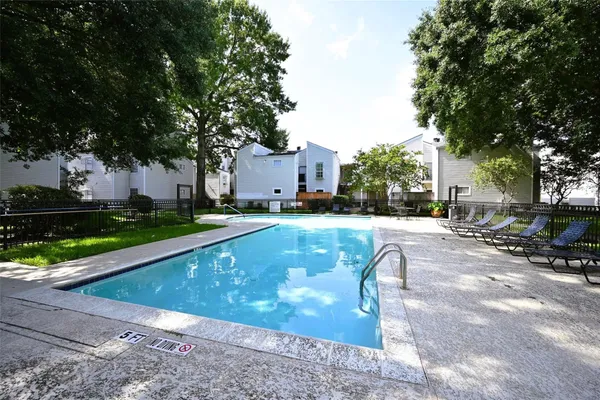 a view of yard with swimming pool and seating space