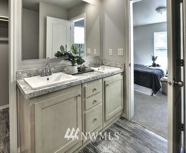 16029 Gibson Road Southwest Tenino, WA 98589 - Photo 17 of 35 a spacious bathroom with a granite countertop sink and a mirror