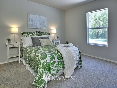 16029 Gibson Road Southwest Tenino, WA 98589 - Photo 23 of 35 a bed sitting in a bedroom next to a window