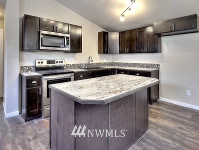 16029 Gibson Road Southwest Tenino, WA 98589 - Photo 25 of 35 a kitchen with a stove and a microwave