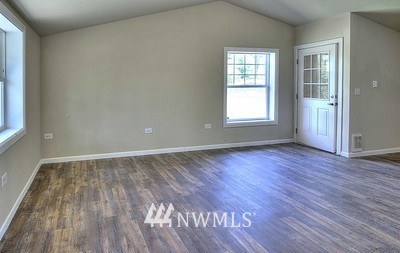 16029 Gibson Road Southwest Tenino, WA 98589 - Photo 26 of 35 a view of an empty room with wooden floor and a window