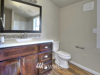 16029 Gibson Road Southwest Tenino, WA 98589 - Photo 28 of 35 a bathroom with a sink a toilet and mirror