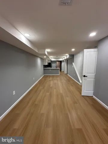 a large white kitchen with a stove a sink and a microwave