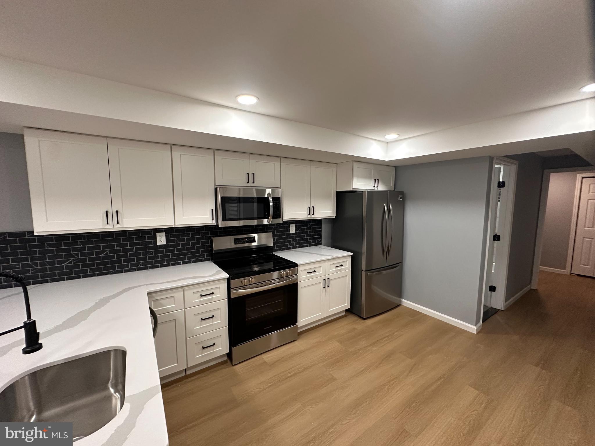 1927 Druid Hill Avenue Baltimore, MD 21217 - Photo 5 of 10 a kitchen with stainless steel appliances granite countertop a refrigerator and a stove top oven