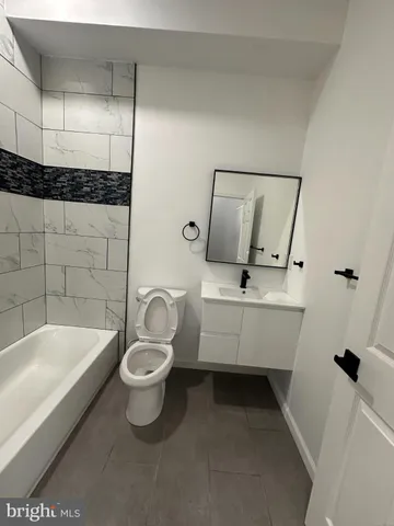 a bathroom with a bathtub a toilet and a shower