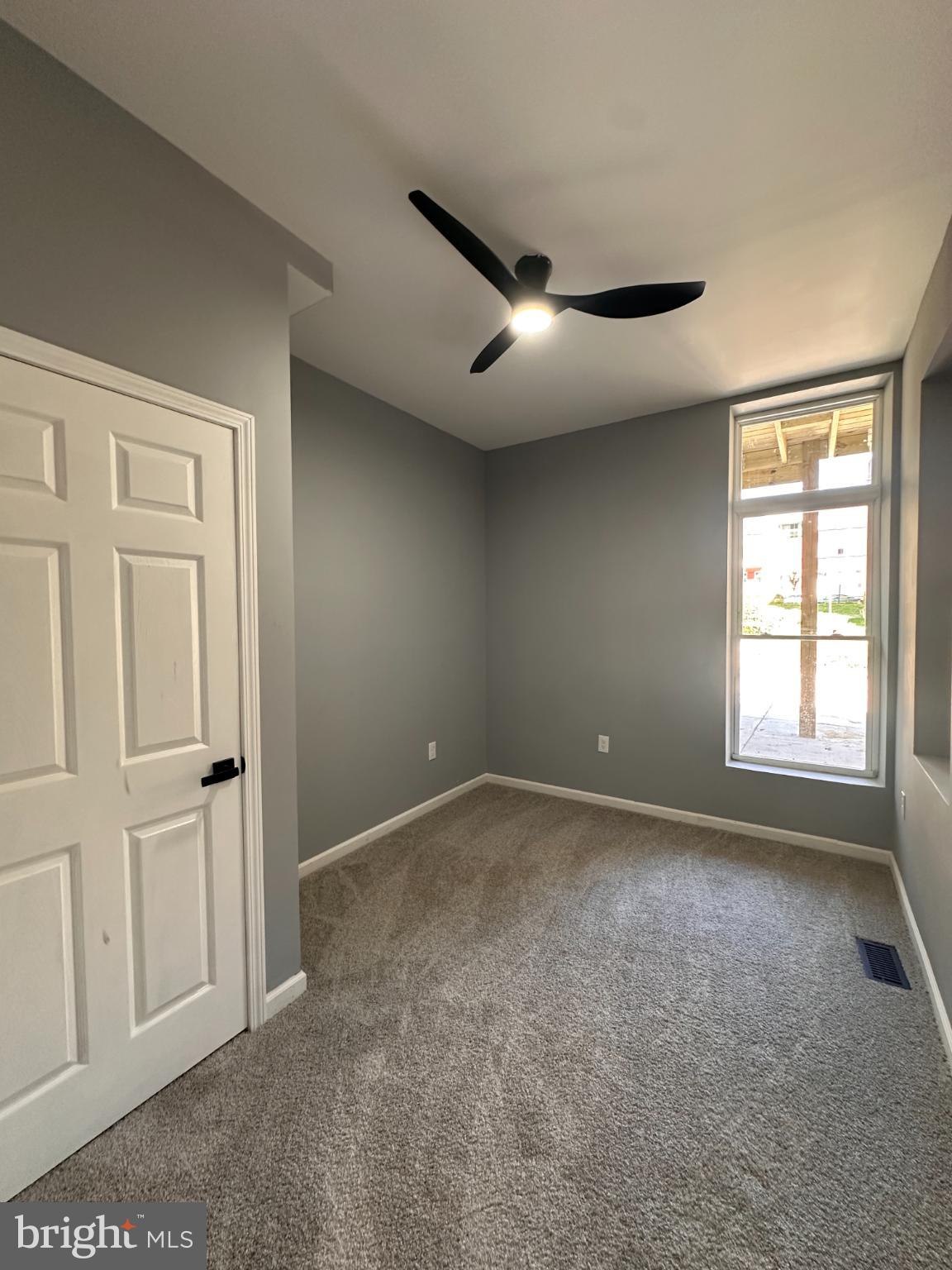 1927 Druid Hill Avenue Baltimore, MD 21217 - Photo 8 of 10 an empty room with windows and closet