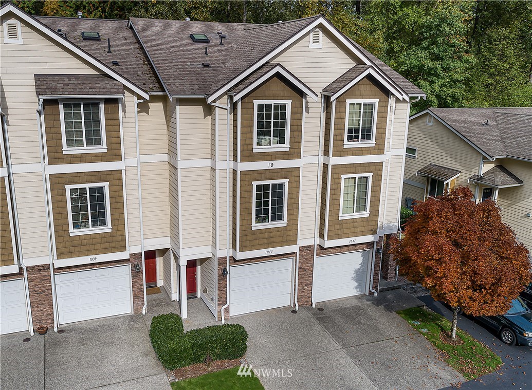 1043 215th Place Southeast Bothell, WA 98021 - Photo 1 of 29 a front view of a house with garden