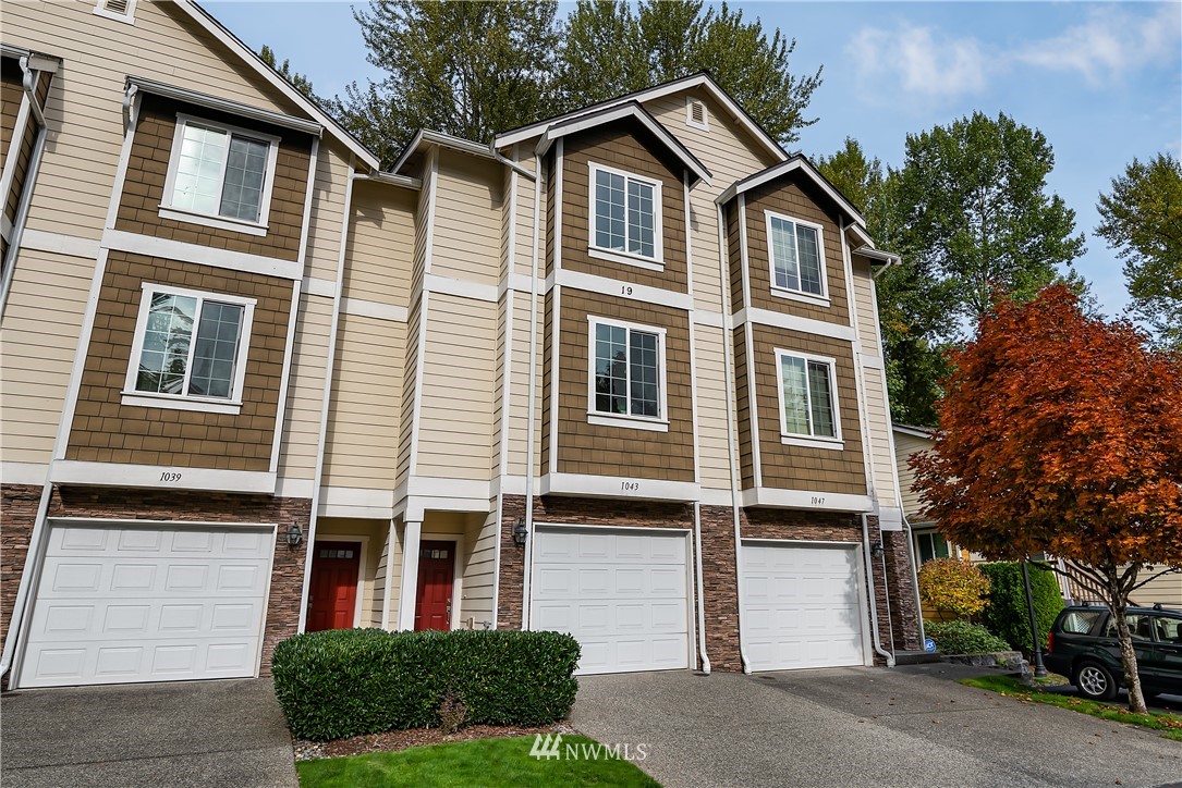 1043 215th Place Southeast Bothell, WA 98021 - Photo 2 of 29 a front view of a house with a yard