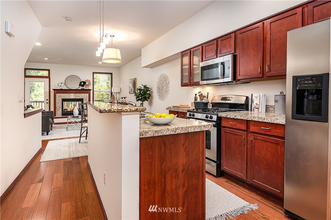 1043 215th Place Southeast Bothell, WA 98021 - Photo 11 of 29 a kitchen with stainless steel appliances granite countertop a refrigerator stove microwave and sink