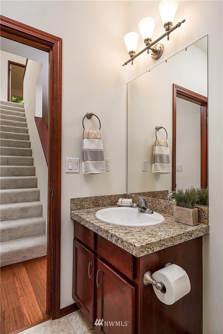 1043 215th Place Southeast Bothell, WA 98021 - Photo 14 of 29 a bathroom with a granite countertop sink and a mirror