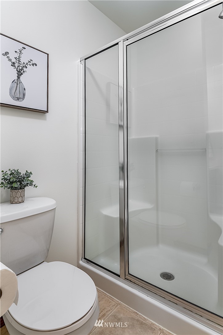 1043 215th Place Southeast Bothell, WA 98021 - Photo 18 of 29 a white toilet next to a bathroom
