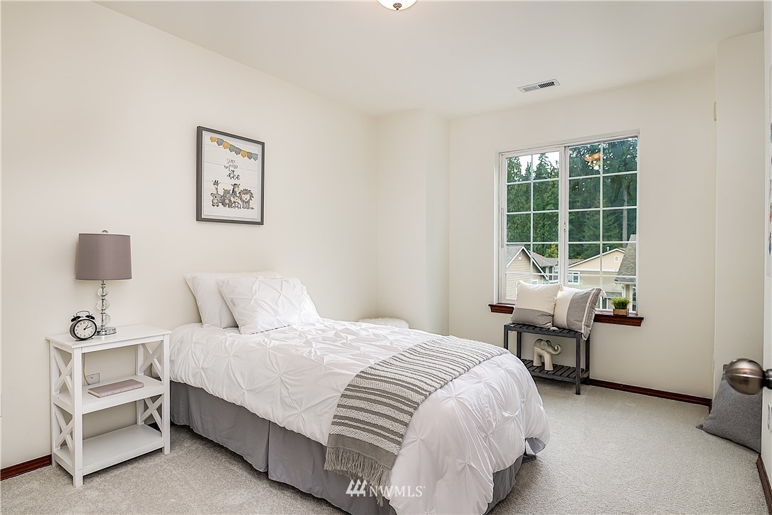1043 215th Place Southeast Bothell, WA 98021 - Photo 20 of 29 a bedroom with a bed and a window