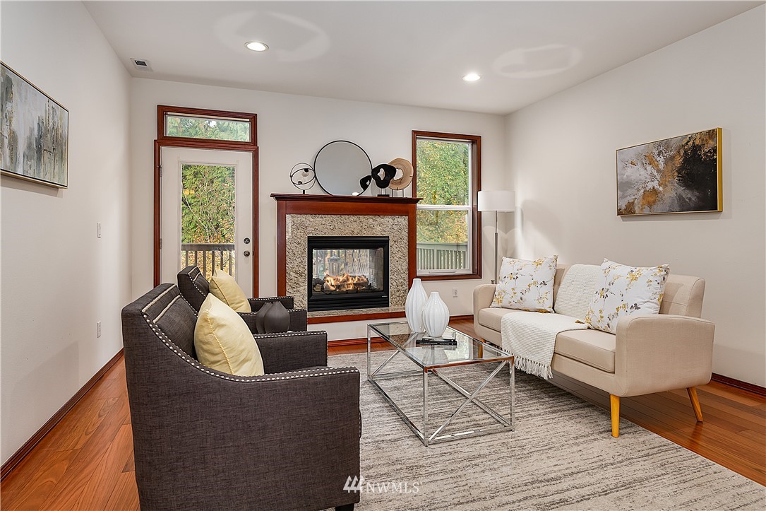 1043 215th Place Southeast Bothell, WA 98021 - Photo 3 of 29 a living room with furniture and a fireplace